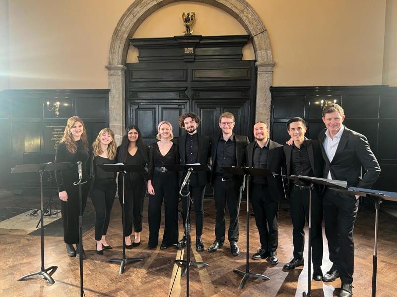 group shot of the 8 person Fellowship Ensemble and Nic Chalmers, all dressed in black